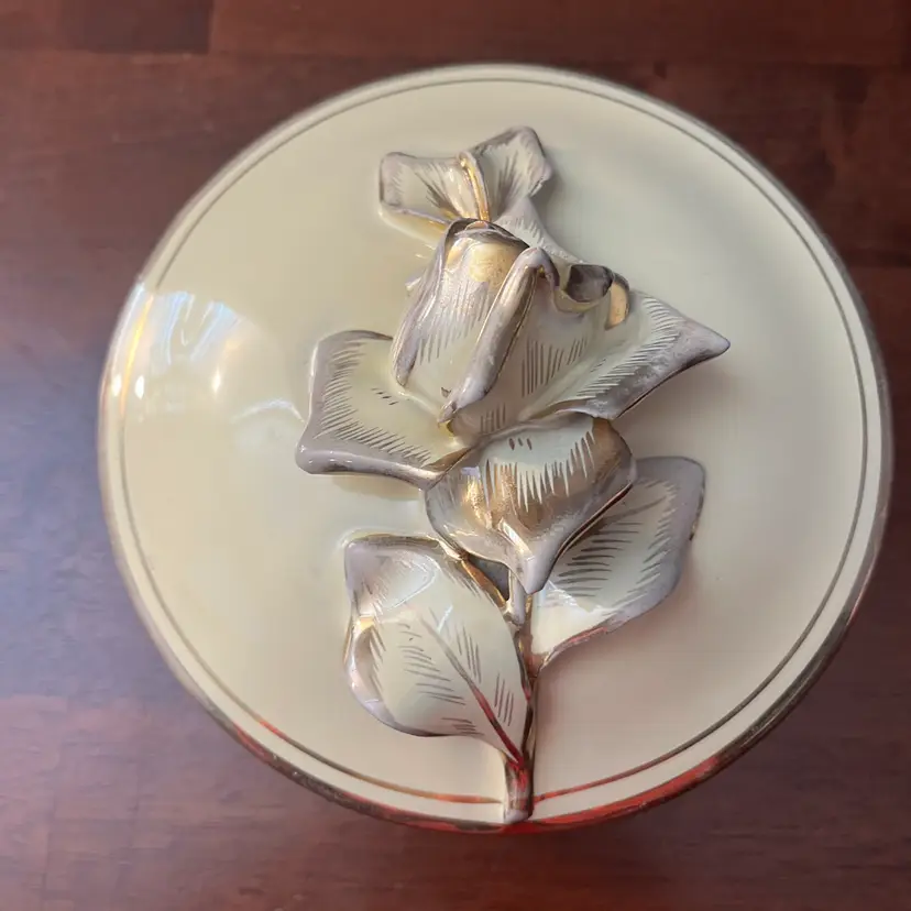 Vintage cream ceramic trinket box with sculpted floral lid and gold trim produced by S.G.A. R. In Florence Italy.6” diameter
