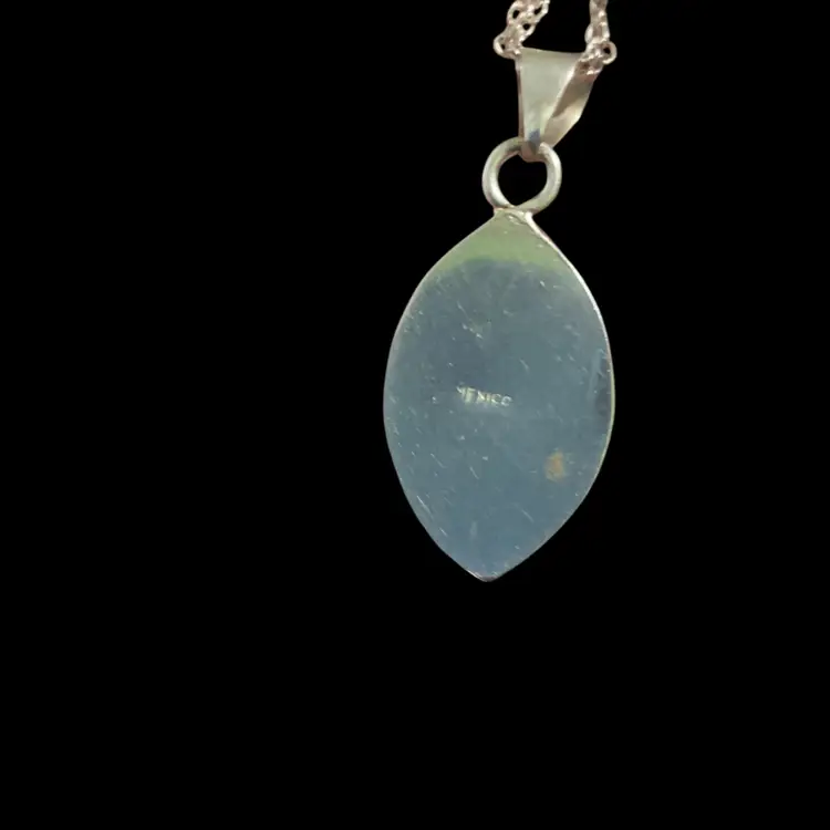 Beautiful Mexico Sterling Marquis Shape Abalone Pendant Set In A Polish Sterling Bezel Frame. The Inlay Crafted Iridescent Abalone Shell Also Known As Paua Shell. Displaying Organic Layers & Gorgeous Hues Of Purple , Pink And Blues. Absolutely Stunning!!! The Chain Is Not Sterling ~ Just Silvertone .