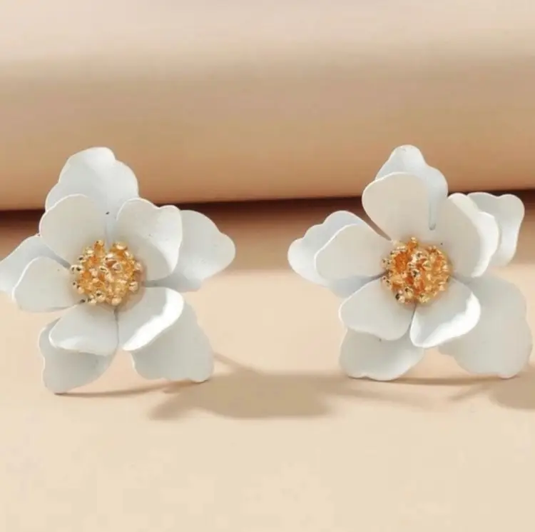 White Flower Stud Earrings With Gold Accents half inch in length.
