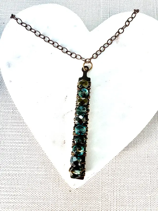 #35 Bronze And Brass Chain Necklace With A 2 1/4” Bronze Bar Wire Wrapped With Ten Silver And Gold Iridescent Beads. A Designs Represents The Gorgeous Blue Waters Of The Oceans And Sand. 24”