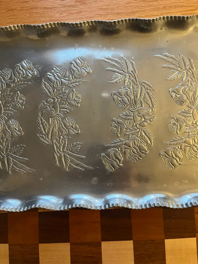 Vintage hand-wrought aluminum serving tray with embossed floral design. Tray is 17.5 x 10.5” Not Including Handles.