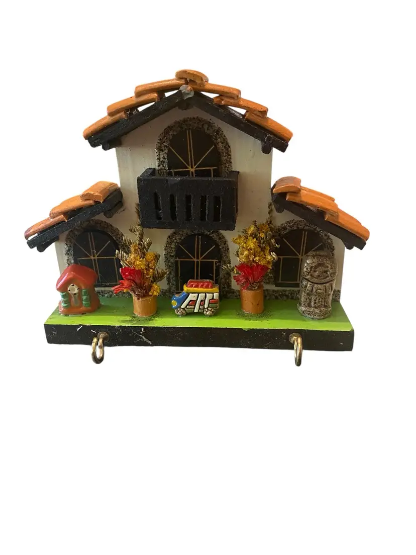 vintage, folk-art style key holder shaped like a house