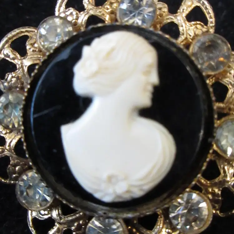 Vintage Gold Tone Metal, Black & White Lucite and Rhinestone Cameo Brooch - 1.25 Inch Diameter