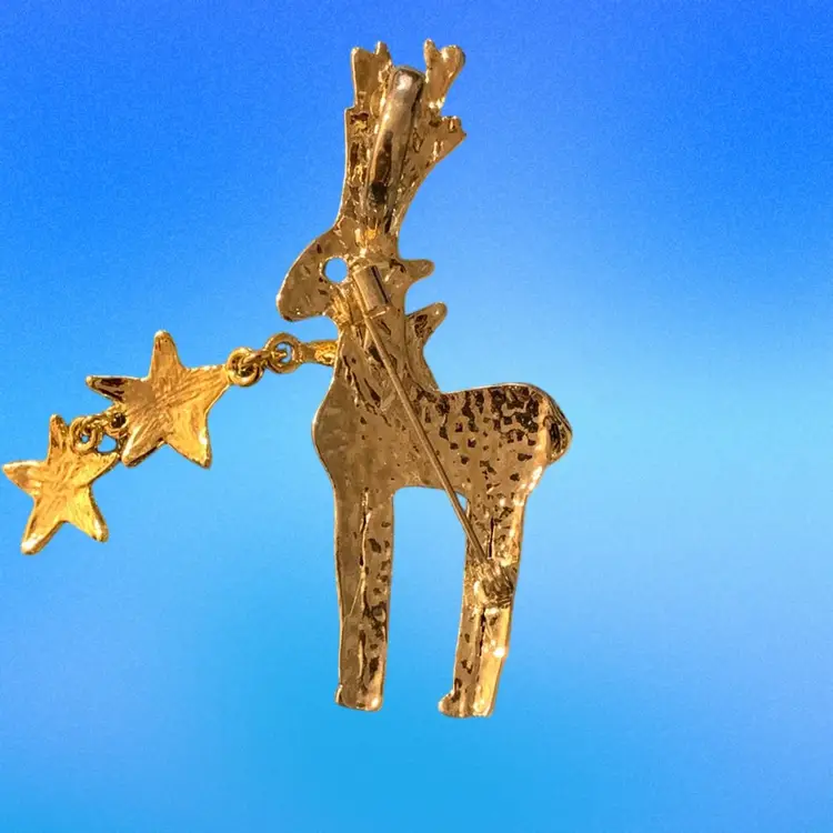 Gold Tone Reindeer With Two Attached Dangling Stars And A Red Rhinestone