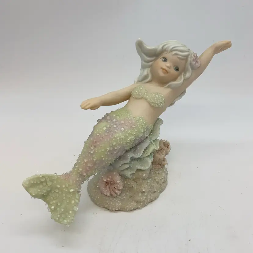 #5016 This is a 1993 Enesco Coral Kingdom mermaid figurine named Crystal.