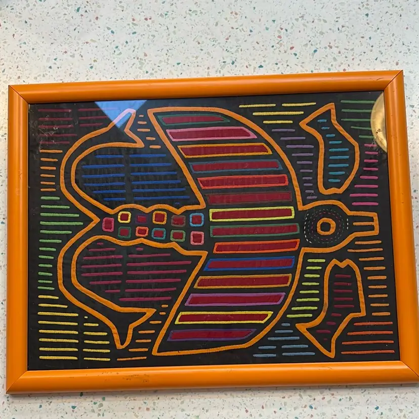 Panama Mola textile art piece, 16 1/2” X 12” Inside Frame. Orange Frame Has Nicks And Dings