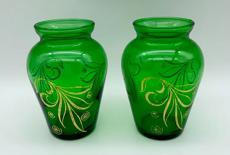 Vintage pair of emerald green Anchor Hocking glass bud vases with hand-painted gold design.