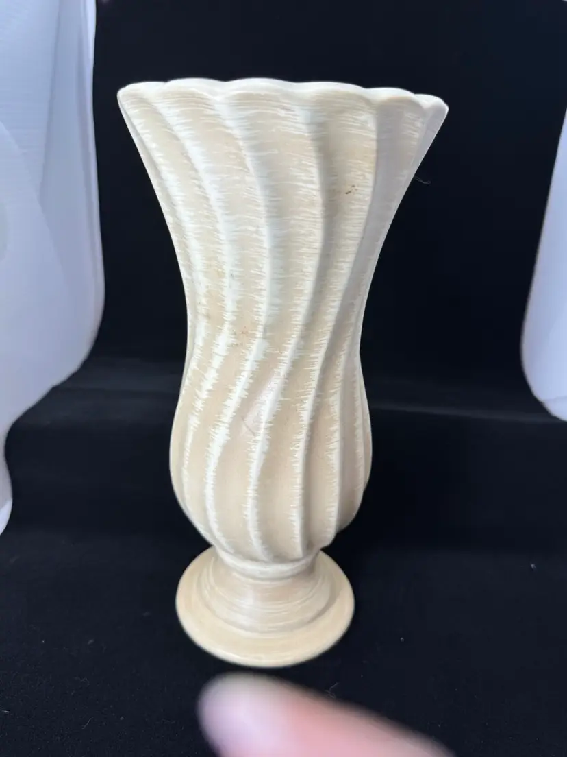A Haeger Swirl Vase with a matte, off-white finish