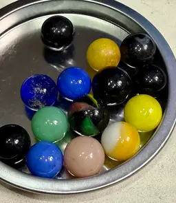 Variety Of Color And Sizes Of Marbles Including One That Glows With UV Light