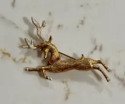 Vintage Hedy Flying Reindeer Brooch – Gold-Tone with Enamel Antlers & Rhinestone Collar – Excellent Condition