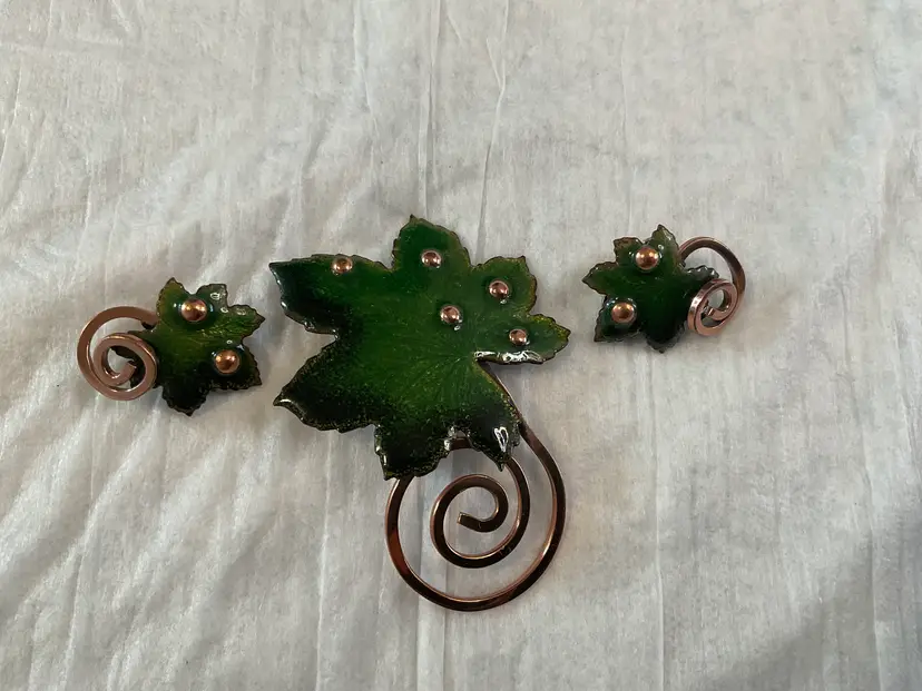 Maple Leaf Brooch & clip earrings Demi parries setby Renoir Matisse line circa 1950s 1960s. Green enamel on copper; stud dots and swirls. Brooch is 3” top of Lear to bottom of swirl and earrings are a little over 1”