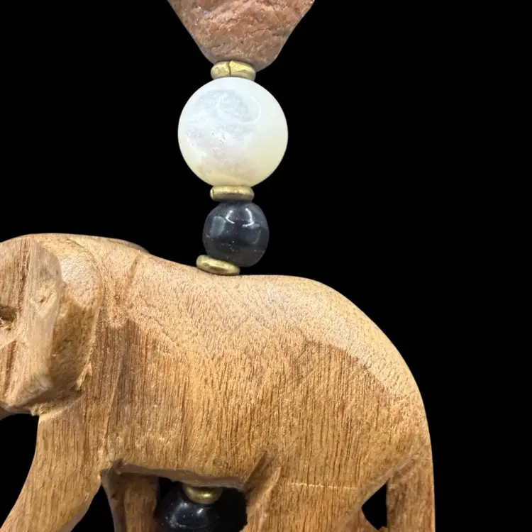 vintage African necklace featuring hand-carved wooden safari animals and mixed material beads- Onyx And MOP?.
