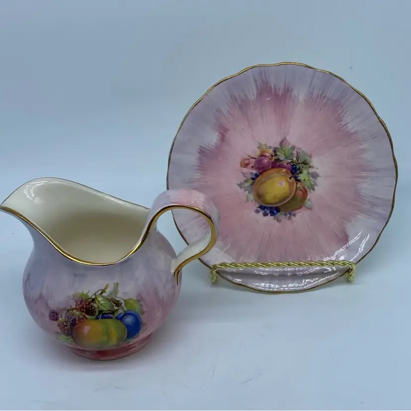 #4803 Royal Staffordshire Clarice Cliff fruit-decorated porcelain creamer and saucer.