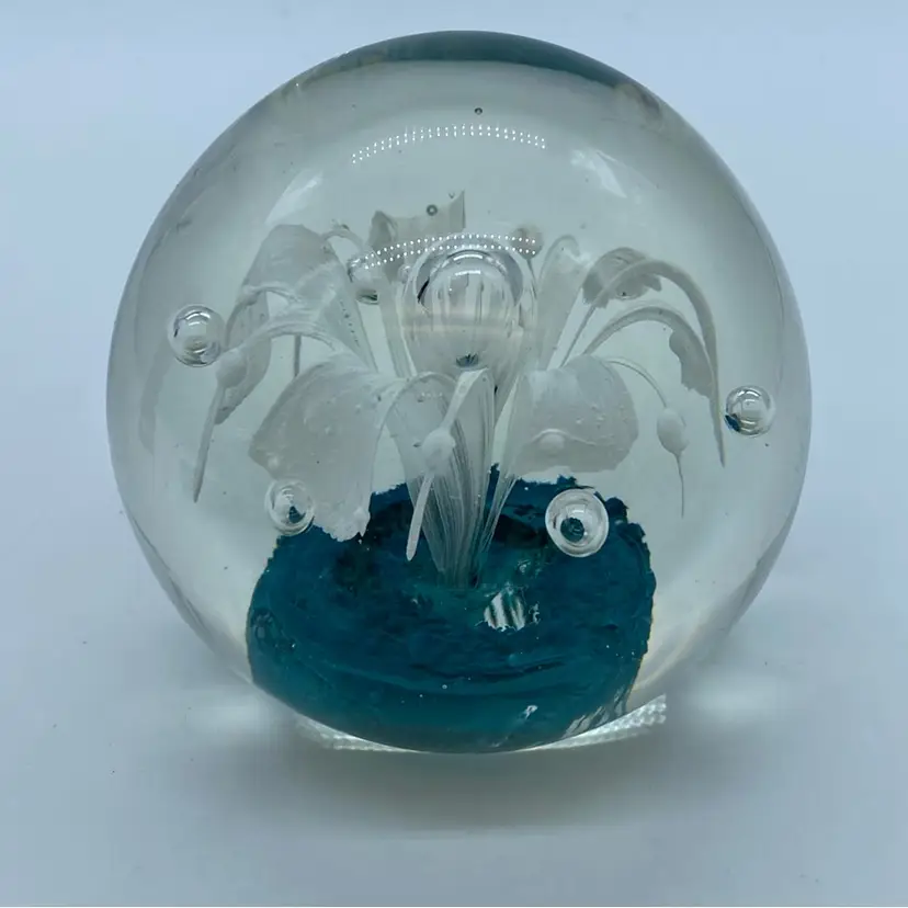 #0040 Clear glass paperweight with white floral design and teal base.