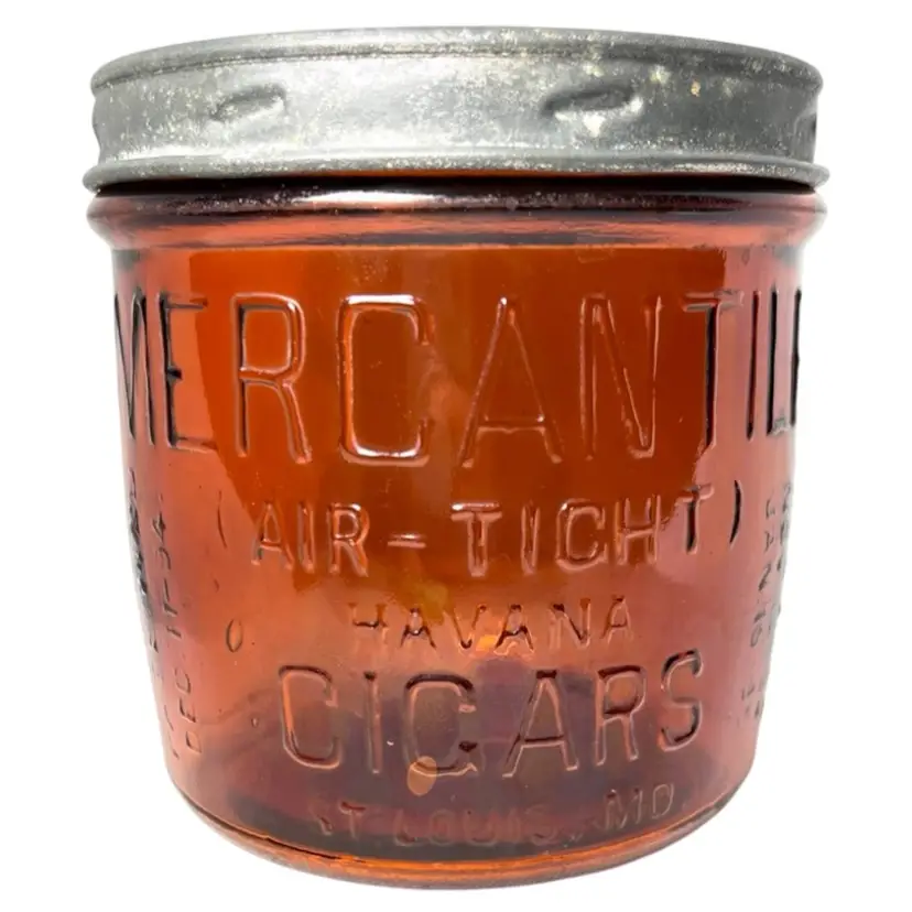 Antique Amber Glass Cigar Humidor Jar With Metal Lid. Stamped On The Glass - Mercantile Air-Tight Havana Cigars St. Louis, MO. 3 Patented Dates 1890s. 5” tall x 5” (top) x 4” (bottom)