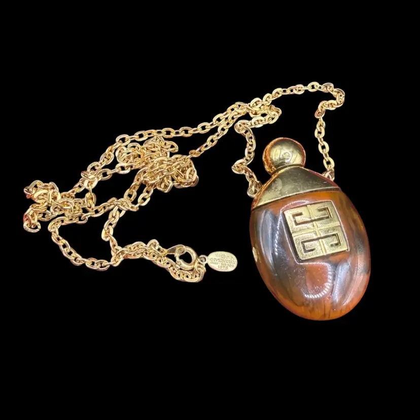 1977 vintage Givenchy perfume bottle pendant necklace with a gold chain