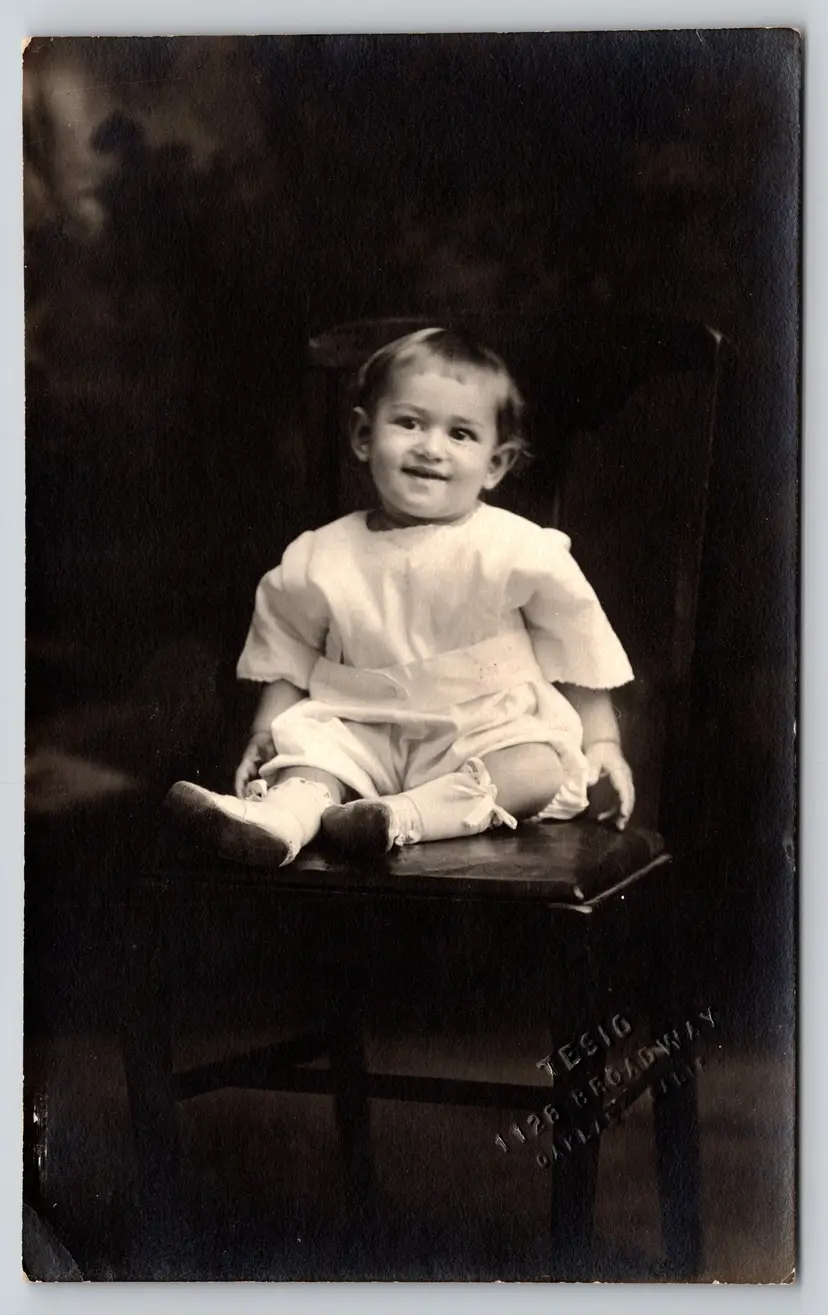 Postcard RPPC Happy Baby in White Gown Sitting on Chair Real Photo Children - 9412