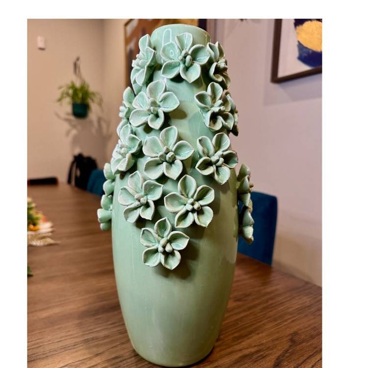 Gorgeous light green ceramic vase decorated with hand-applied, sculpted flowers. Artist unknown