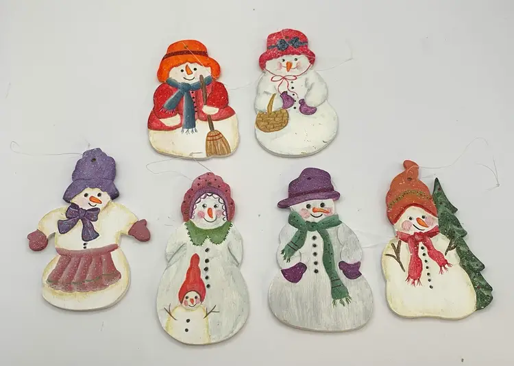 6 Cute hand painted wood snowman ornaments. Approximately 3 1/2 inches tall. Signed by the artist on the back.(Cowham? 1995)