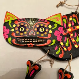 Alejibre Cat with dangling legs, beautiful bright colors on black