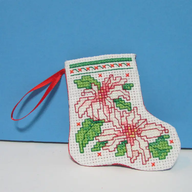 completed handmade cross stitch small Christmas stocking ornament poinsettia