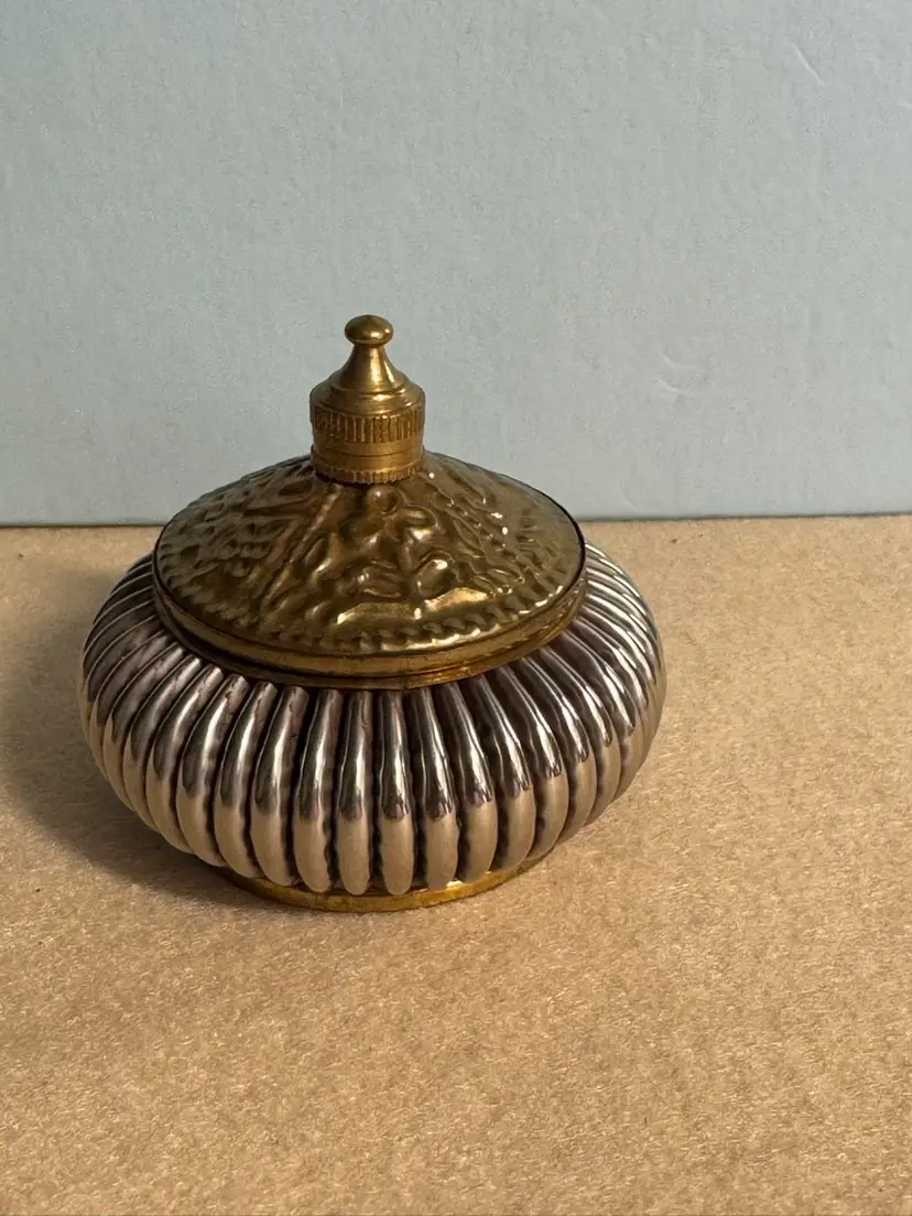 Vintage ribbed metal lidded container with a decorative brass lid