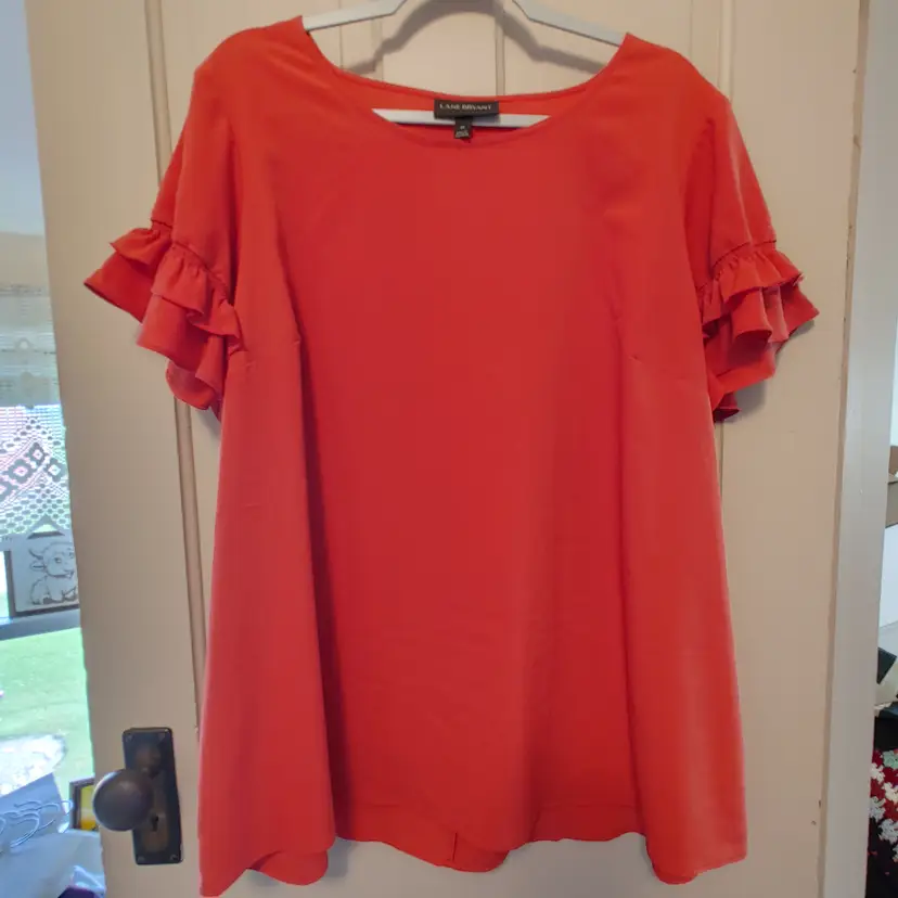 Top- Brand: Lane Bryant. Size 20, 2X. Orange top. Material- 100% polyester. No callouts.