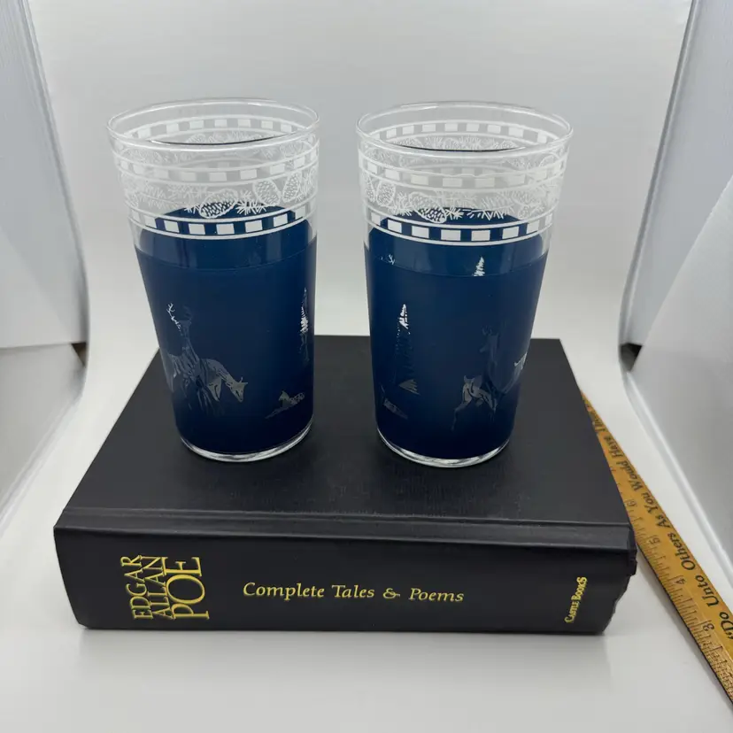 A pair of vintage Libbey Glass tumblers with forest scene etchings.