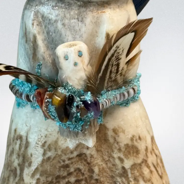 Native American Zuni Marvelita Phillips Antler Altar Doll Baby Fetish 
Turquoise Chips/Feathers/Bead Accents 
5-1/2” T (top of Feather)  x 1-3/8” L x 1” W
4-1/2” W/O  Feather
