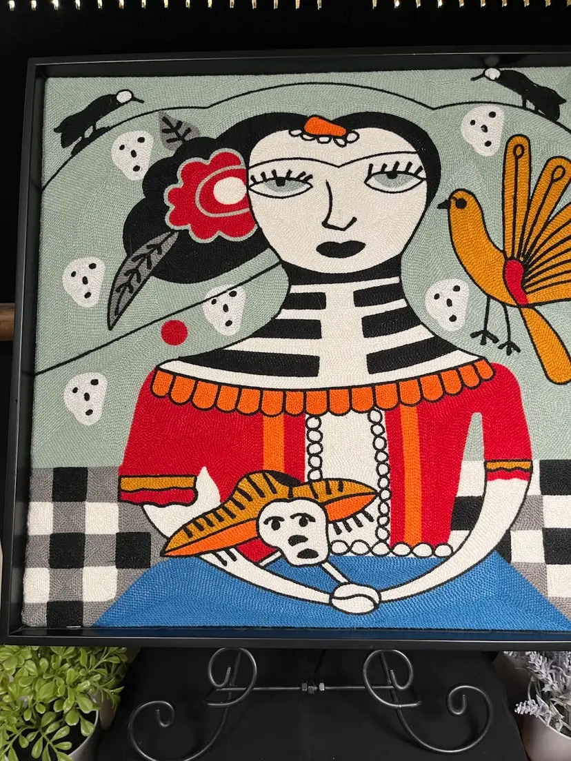 Stylized representation of Frida Kahlo w/ Elements Associated w/ Dia De Los Muertos (Day of the Dead). Embroidered (Probably Machine) Framed Art-Lot 60