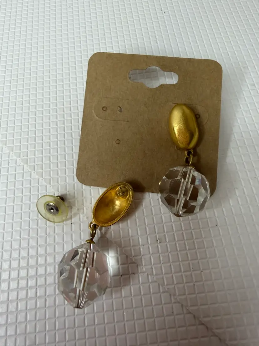 these are vintage dangle earrings typically featuring gold-tone metal studs with large, faceted clear Drop.