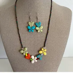 Iridescent Aurora Borealis Beaded Necklace with Carved Howlite Butterflies And Matching Earrings