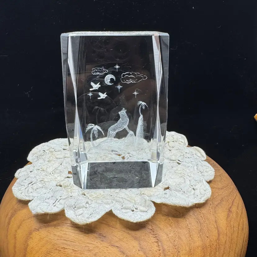 A 3D laser-etched crystal block featuring a howling wolf scene.