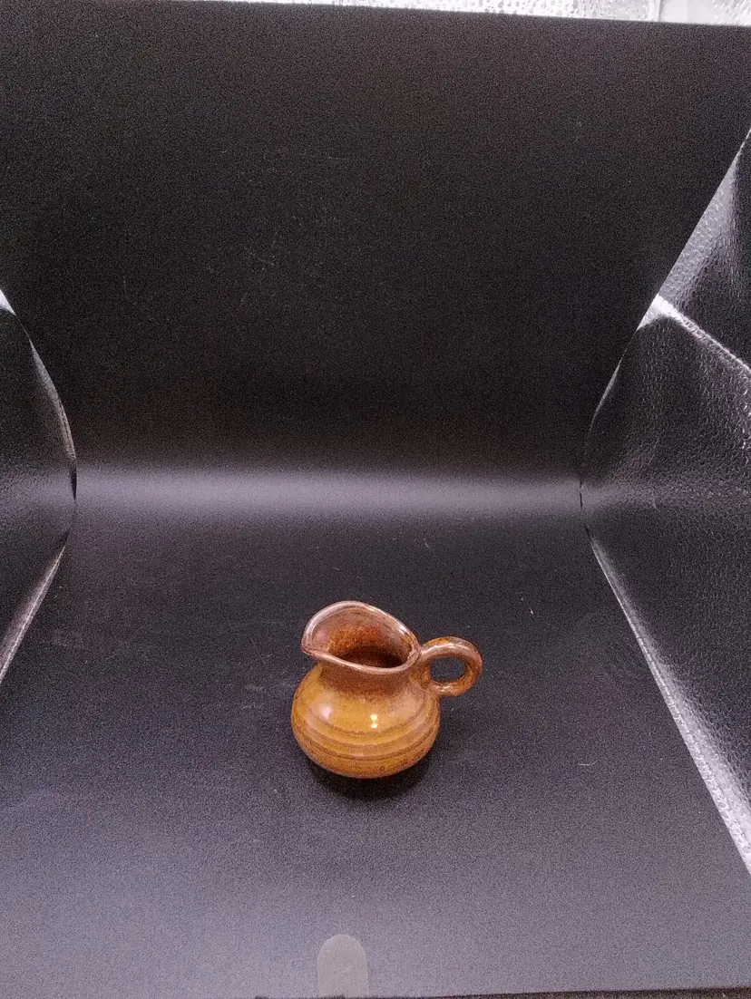 Tiny brown glazed pottery creamer/pitcher 2"