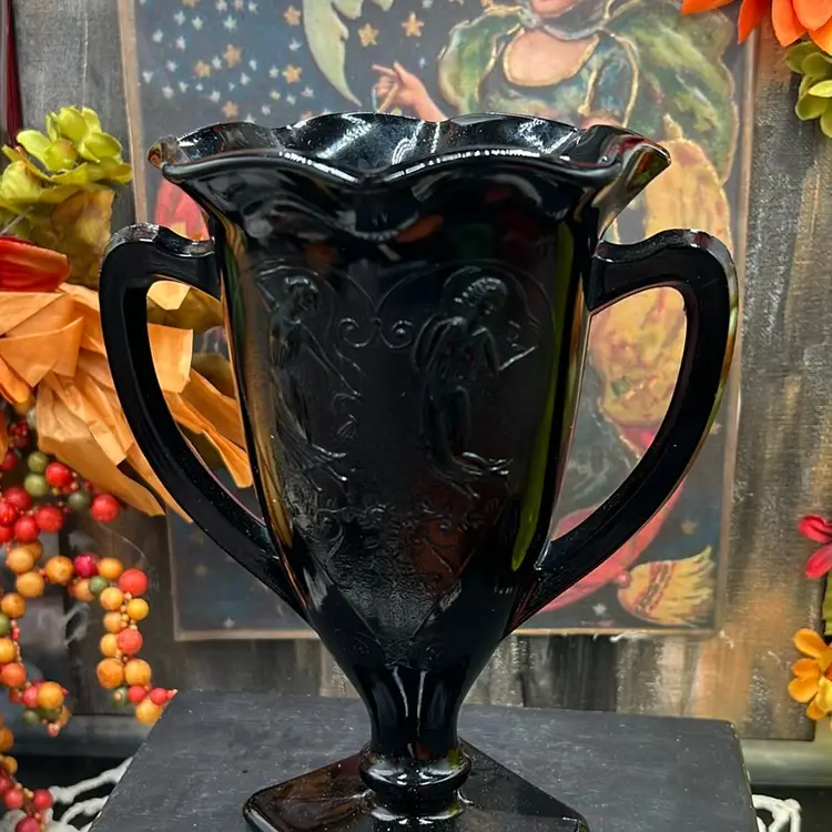 This is a vintage L.E. Smith black glass vase with embossed figures. Dancing Nymphs Deep Black Glass, 7”tall X 4” Wide