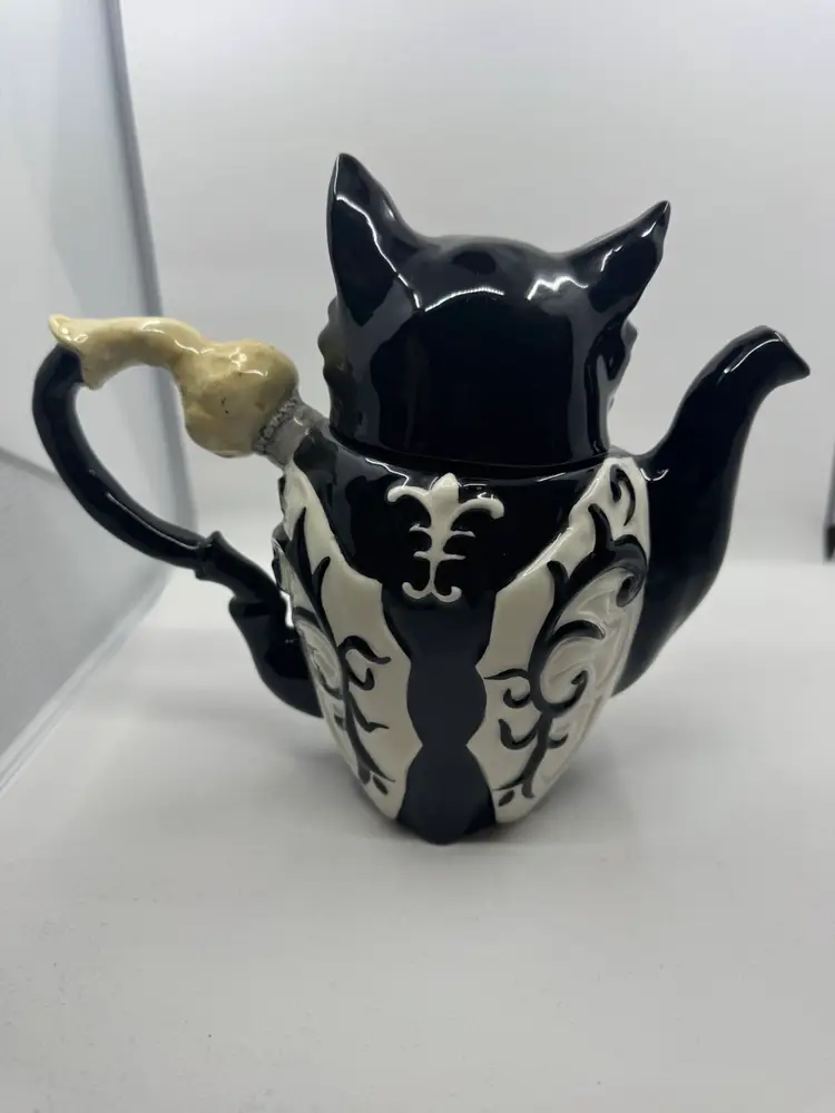 A Blue Sky Clayworks black ceramic wizard owl teapot with decorative scrollwork 2011