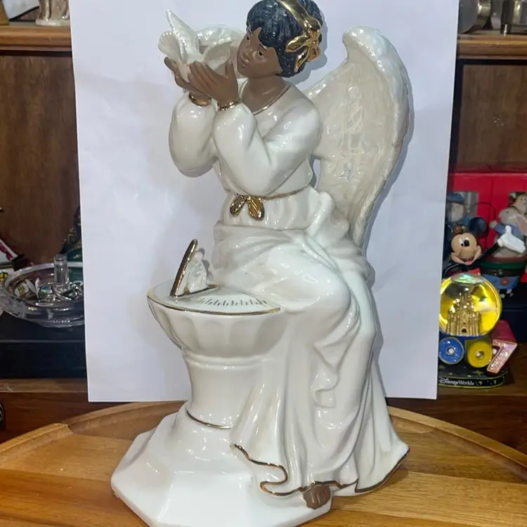 Porcelain angel on sundial holding Dove 10 inches tall