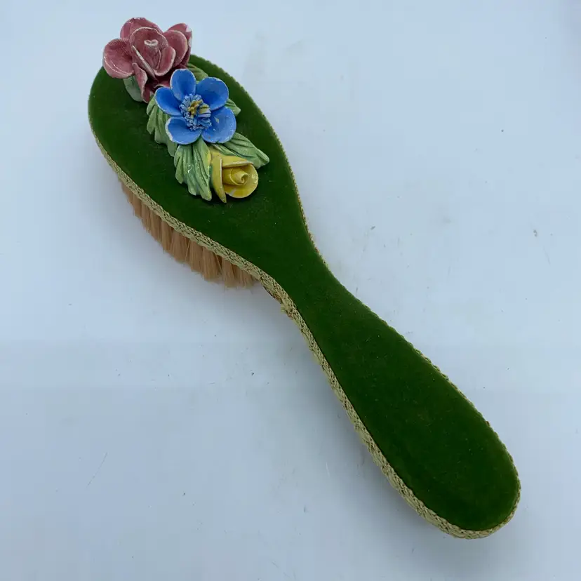 #4220 Vintage velvet hairbrush with applied porcelain floral decorations.
