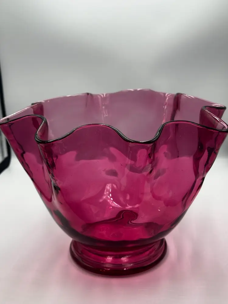 A12 Cranberry glass bowl with a ruffled edge and pedestal base