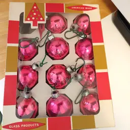 Box of 11 pink plus 1 silver glass ornaments. American Made by Coby. 1 3/4 in diameter.