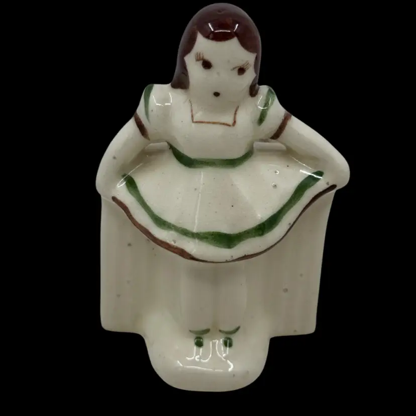 Vintage ceramic figurine of a girl, possibly Shirley Temple, as a planter.