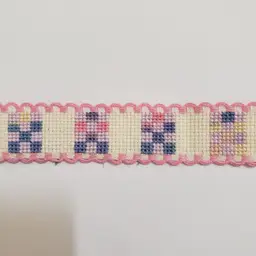 New Cross-stitched Ribband quilt themed ivory with pink trim.