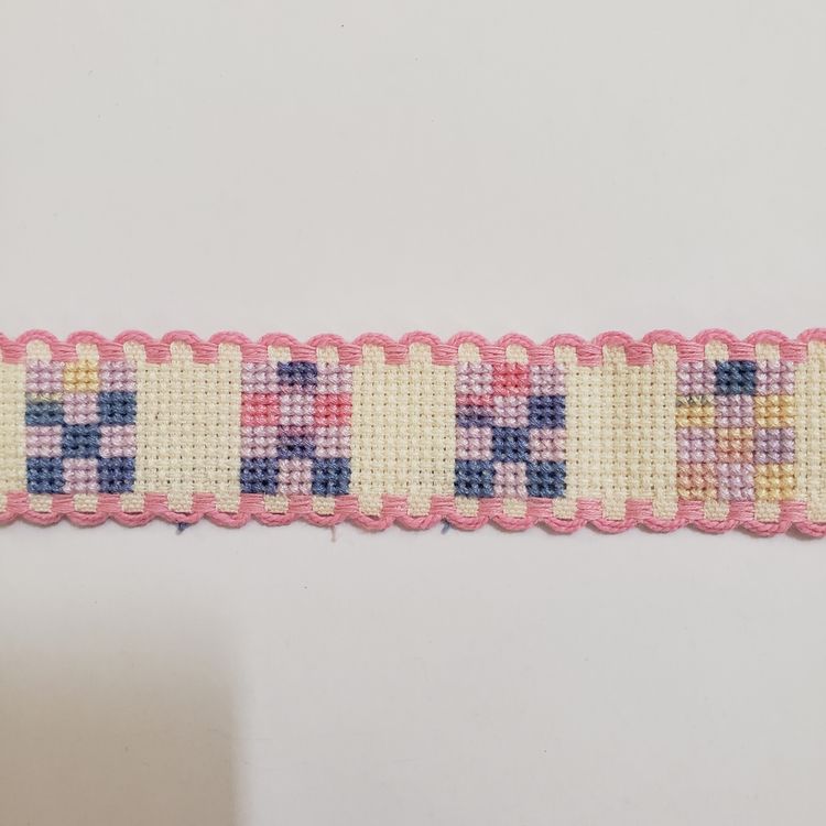 New Cross-stitched Ribband quilt themed ivory with pink trim.
