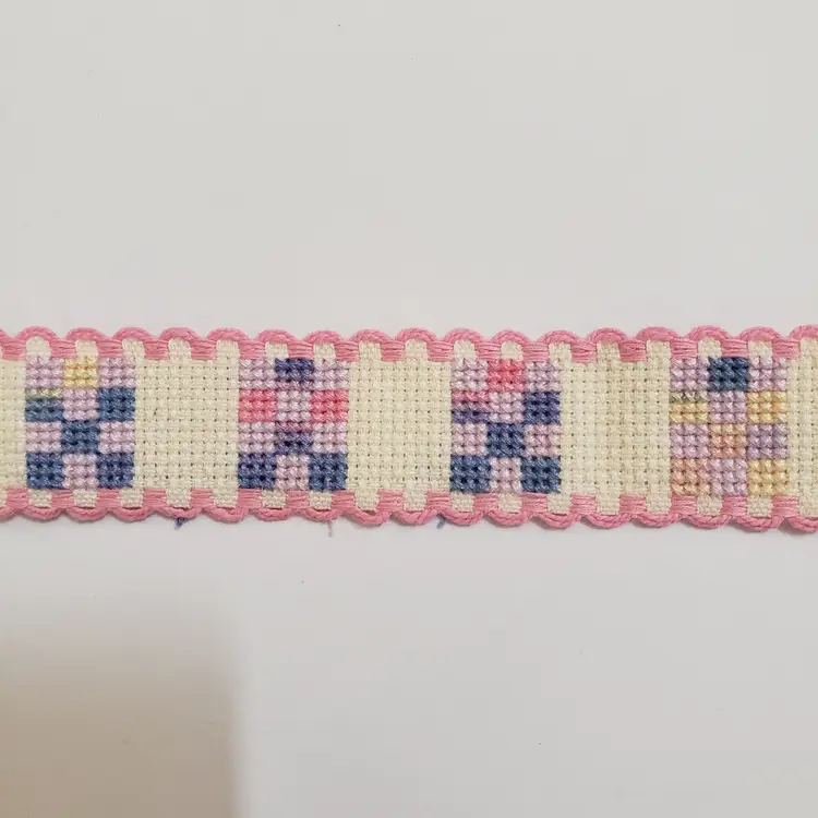 New Cross-stitched Ribband quilt themed ivory with pink trim.