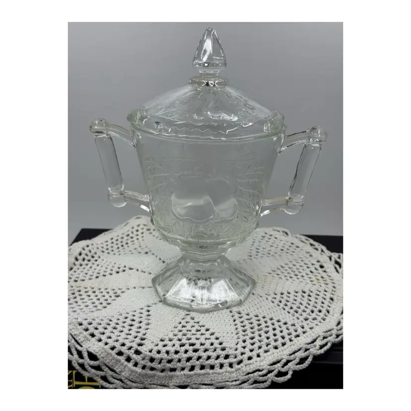 Clear glass lidded sugar bowl with embossed pears and leaves by Jeannette Glass, Circa 1930’s
