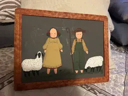Folk art painting of shepherd children with sheep in wooden frame.