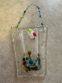 Fused glass wall hanging vase with butterfly decoration.