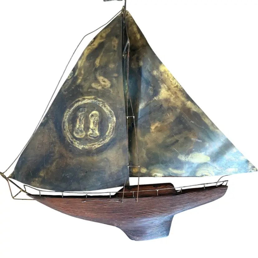 Mid-Century Modern mixed metal sailboat wall sculpture featuring brass or copper sails and a wooden hull