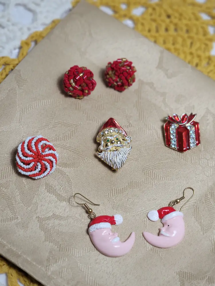 Lot of Christmas earrings a couple small brooches and a signed Avante Santa brooch