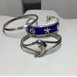 Ocean Themed Bracket Lot 
Blue & Silver Enameled 7” Adj
Dolphin Silvertone Adjustable 7.5”
Silvertone Bangle 8”